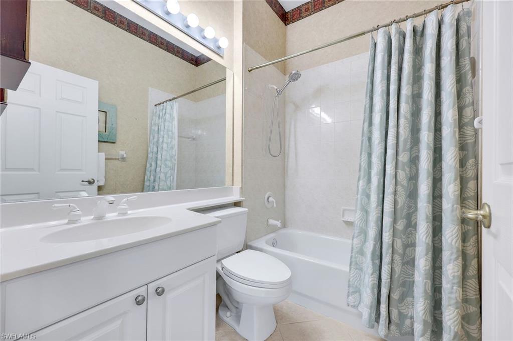 9375 Oak Strand Drive Estero, FL 34135 - Photo 18 of 30 a bathroom with a sink a toilet and shower