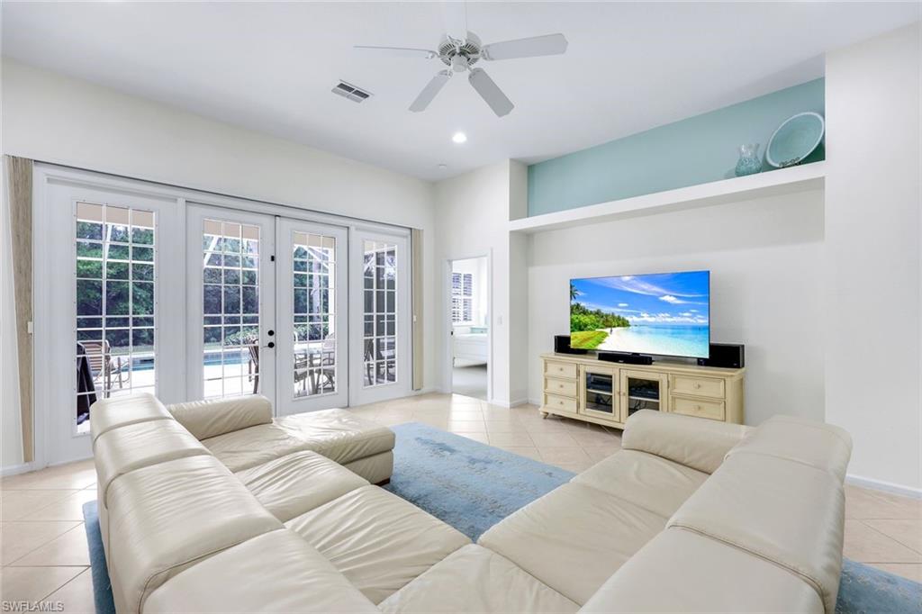 9375 Oak Strand Drive Estero, FL 34135 - Photo 5 of 30 a living room with furniture and a flat screen tv