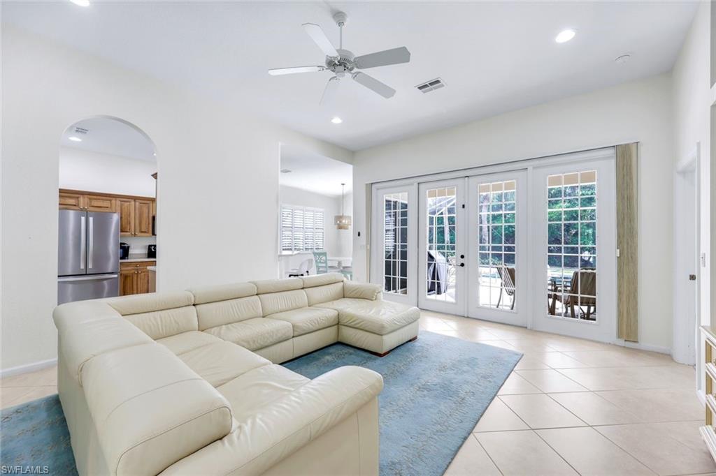 9375 Oak Strand Drive Estero, FL 34135 - Photo 6 of 30 a living room with furniture and large windows