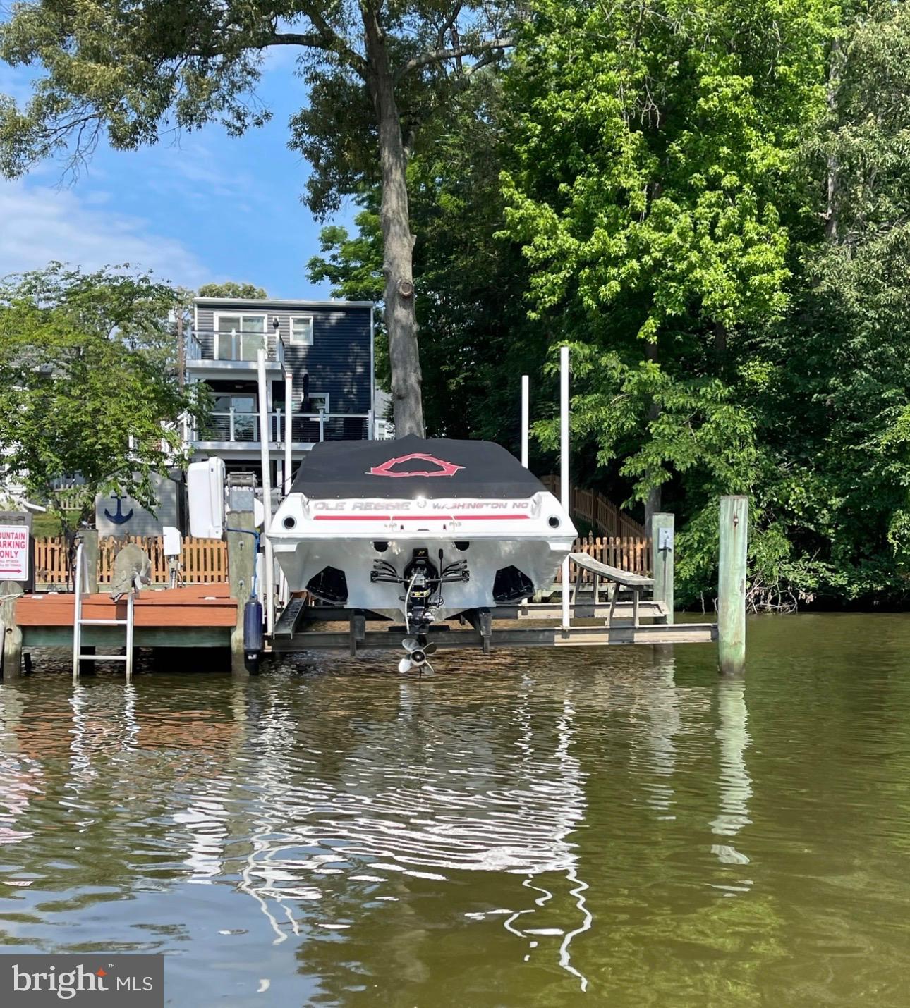 787 Powhatan Beach Road Pasadena, MD 21122 - Photo 8 of 12 a view of a lake with house swimming pool and outdoor seating