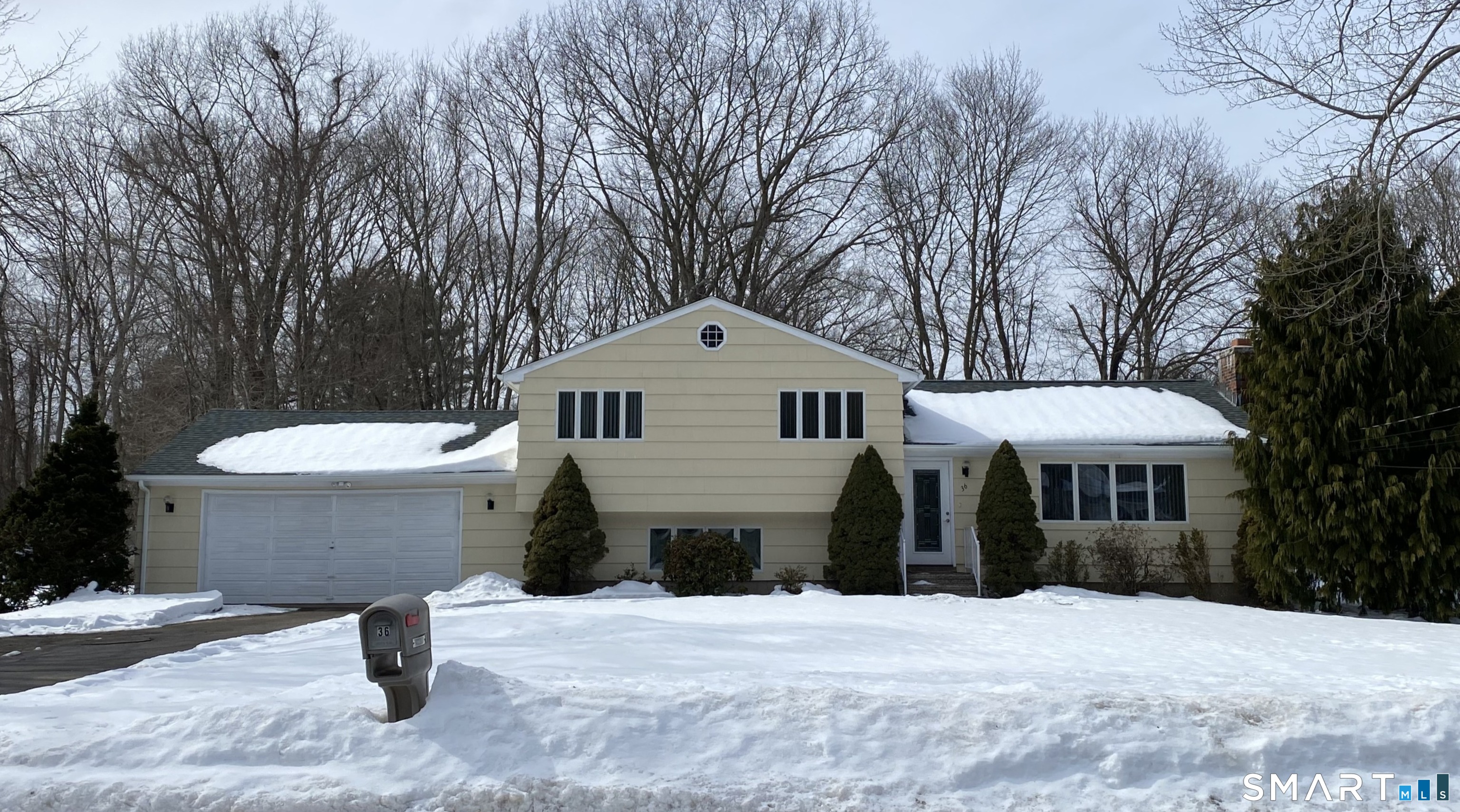 36 Corey Road North Haven, CT 06473 - Photo 1 of 25 a front view of a house with a yard and large trees