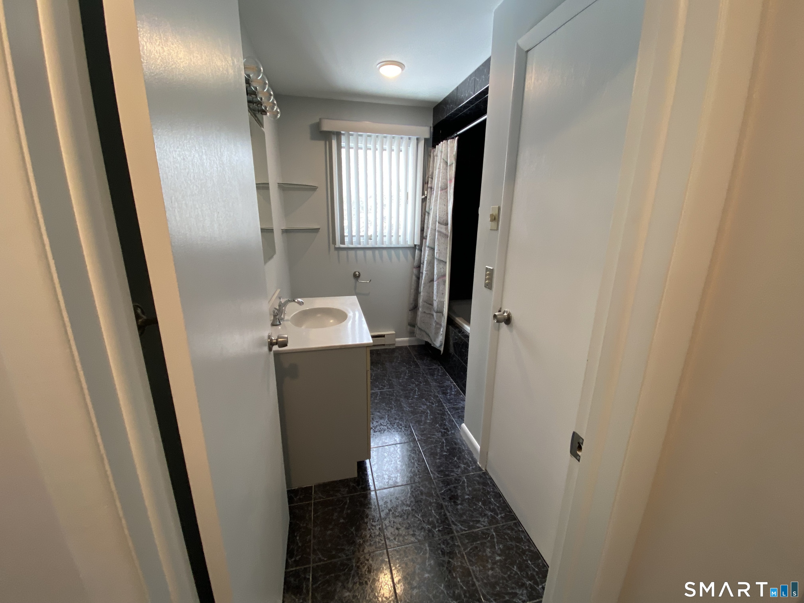 36 Corey Road North Haven, CT 06473 - Photo 11 of 25 a hallway with wooden floor and stairs