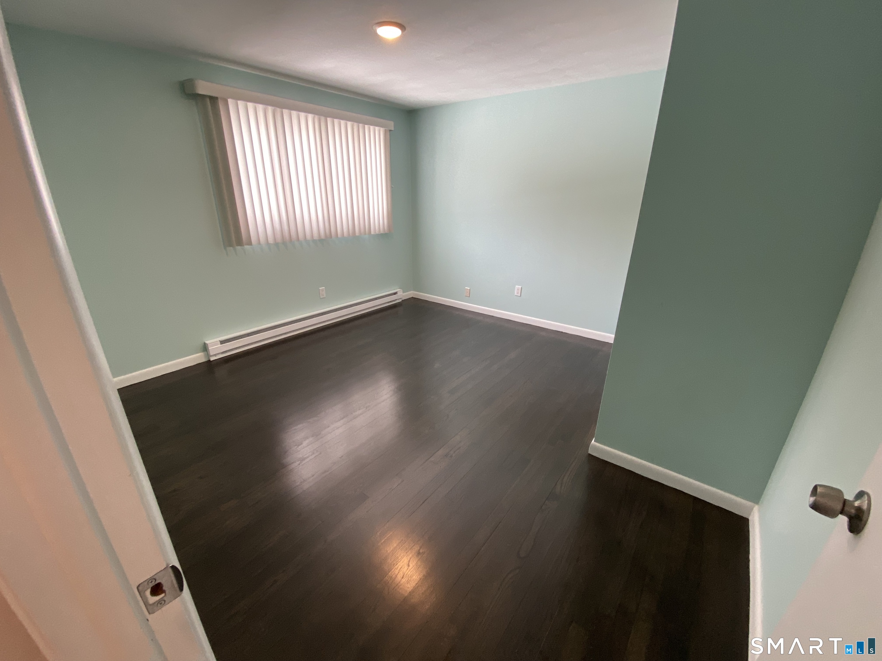 36 Corey Road North Haven, CT 06473 - Photo 14 of 25 an empty room with wooden floor and windows