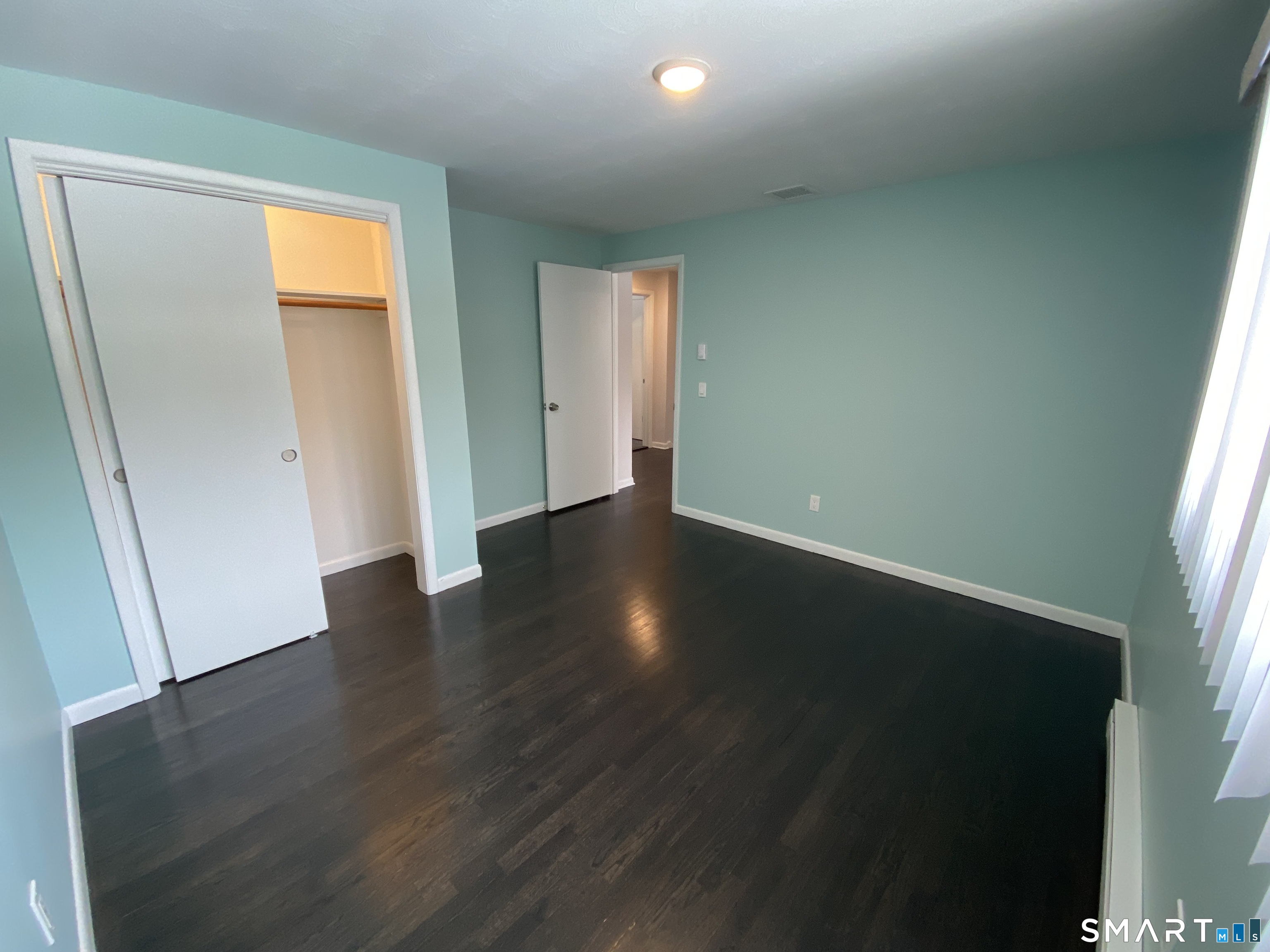 36 Corey Road North Haven, CT 06473 - Photo 15 of 25 an empty room with wooden floor and windows