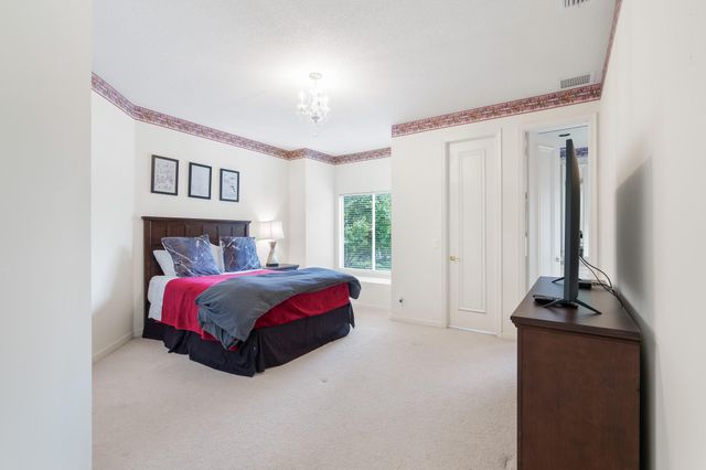 a bedroom with a bed and a tv