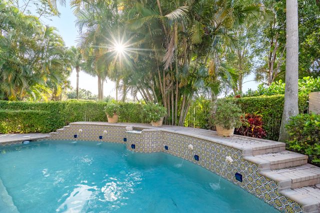 a view of a swimming pool and a lawn chairs