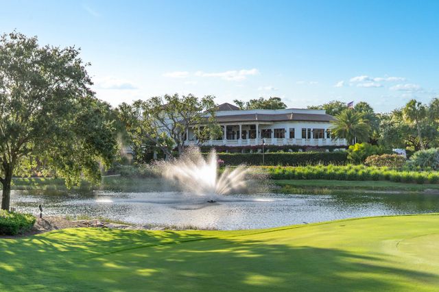 a view of swimming pool with outdoor seating and house in the background