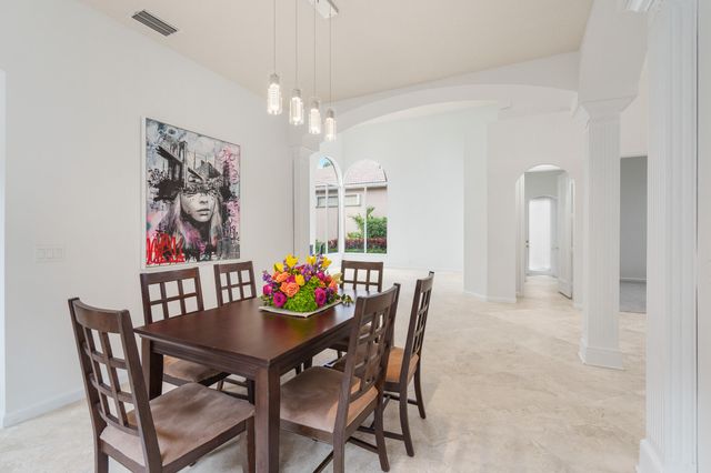 a view of a dining room with furniture and chandelier