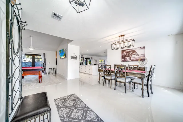 a dining room with furniture and wooden floor