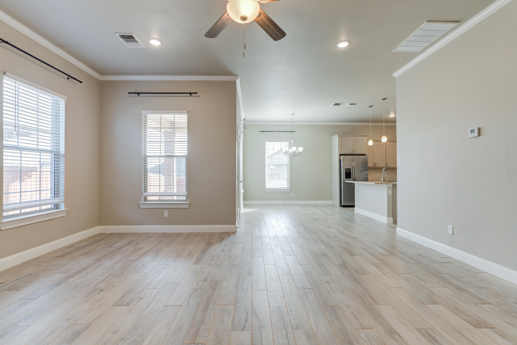 7633 87th Street Lubbock, TX 79424 - Photo 11 of 47 an empty room with wooden floor and windows