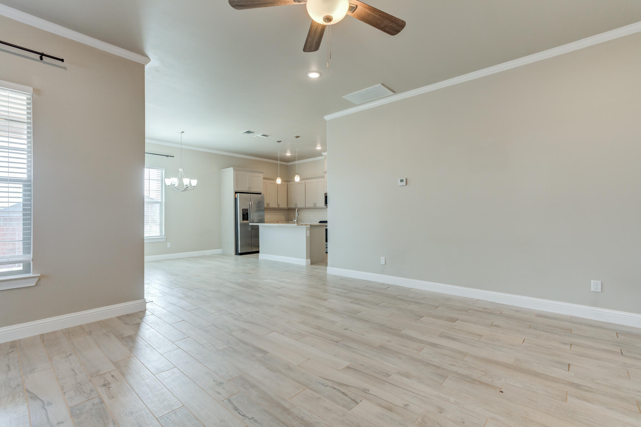 7633 87th Street Lubbock, TX 79424 - Photo 14 of 47 wooden floor in an empty room with a window