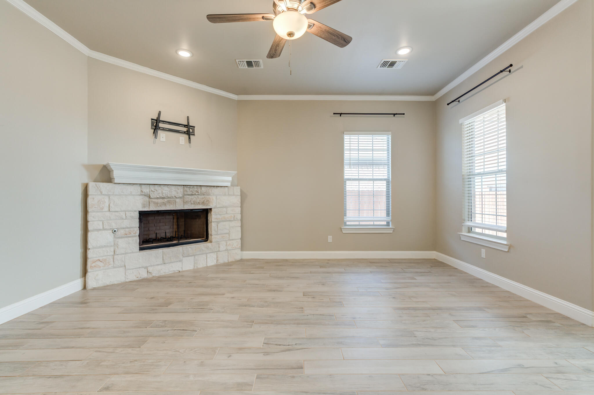 7633 87th Street Lubbock, TX 79424 - Photo 18 of 47 a view of an empty room with a window and fireplace