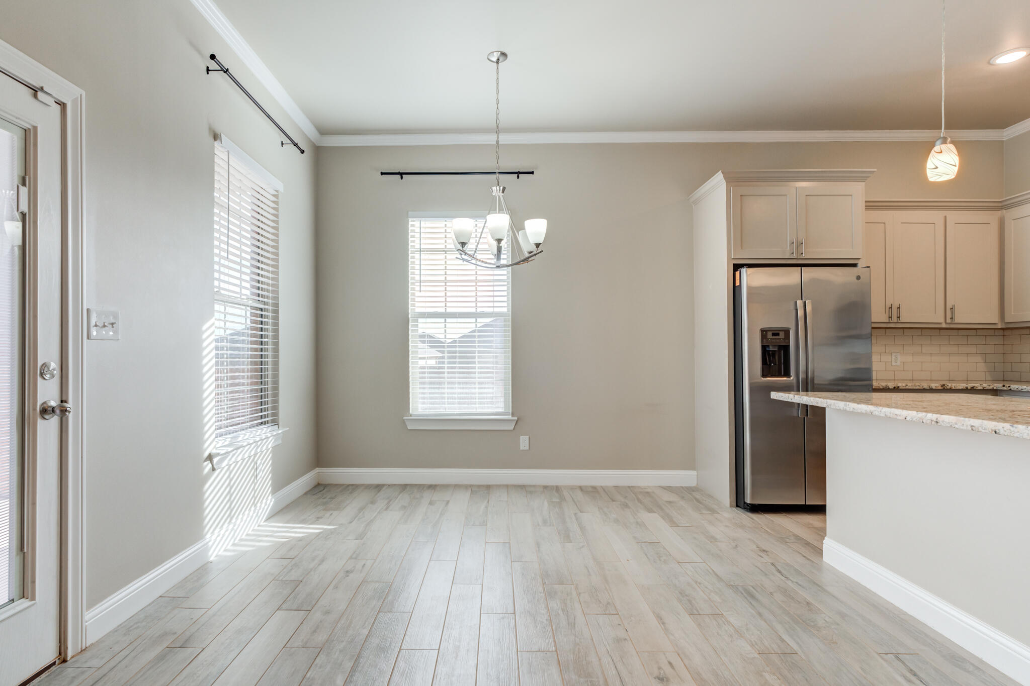 7633 87th Street Lubbock, TX 79424 - Photo 19 of 47 a view of a kitchen with a dishwasher cabinets and wooden floor