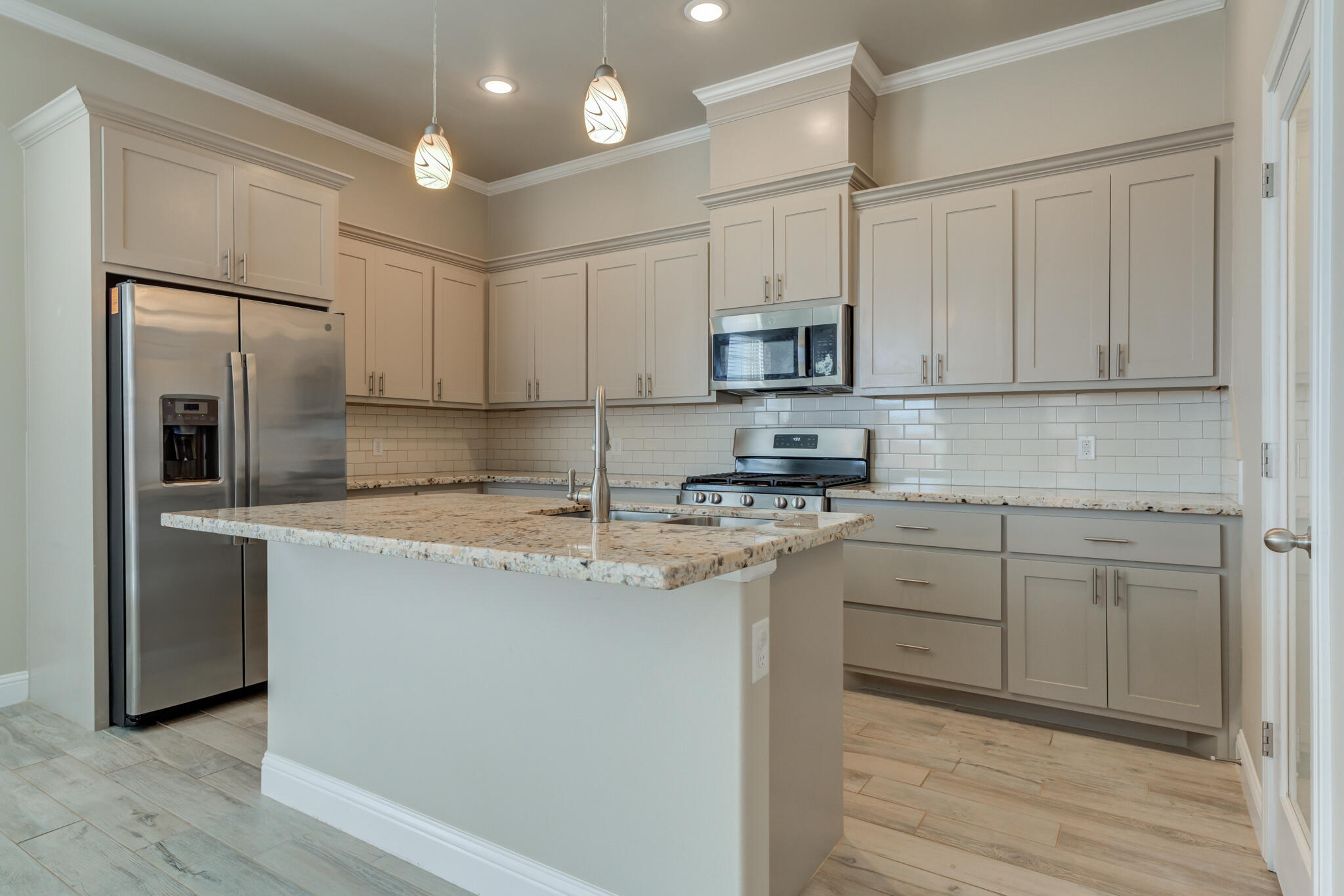7633 87th Street Lubbock, TX 79424 - Photo 20 of 47 a kitchen with stainless steel appliances granite countertop a stove a sink and a refrigerator