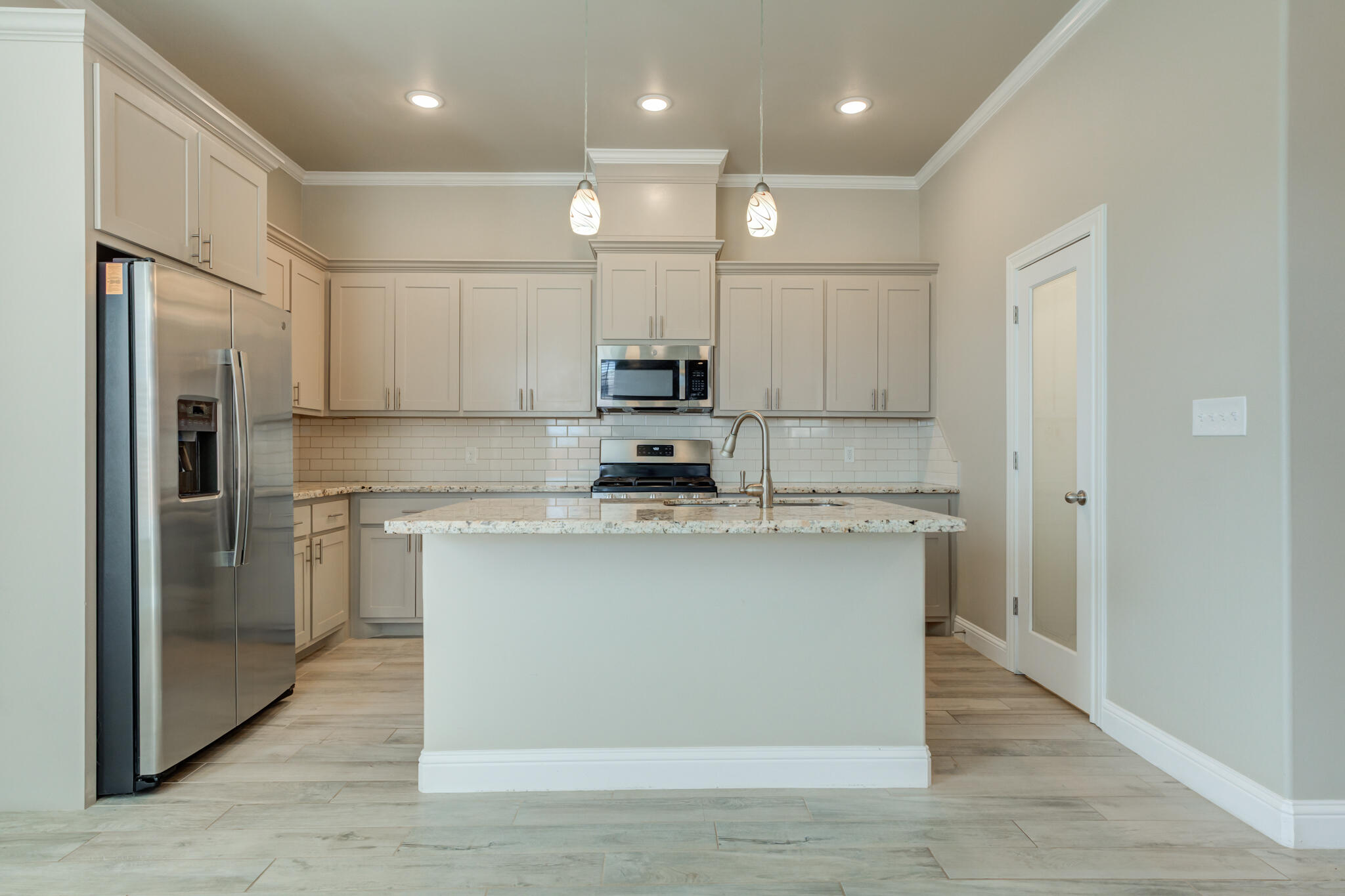 7633 87th Street Lubbock, TX 79424 - Photo 21 of 47 a kitchen with stainless steel appliances granite countertop a stove a refrigerator and a sink