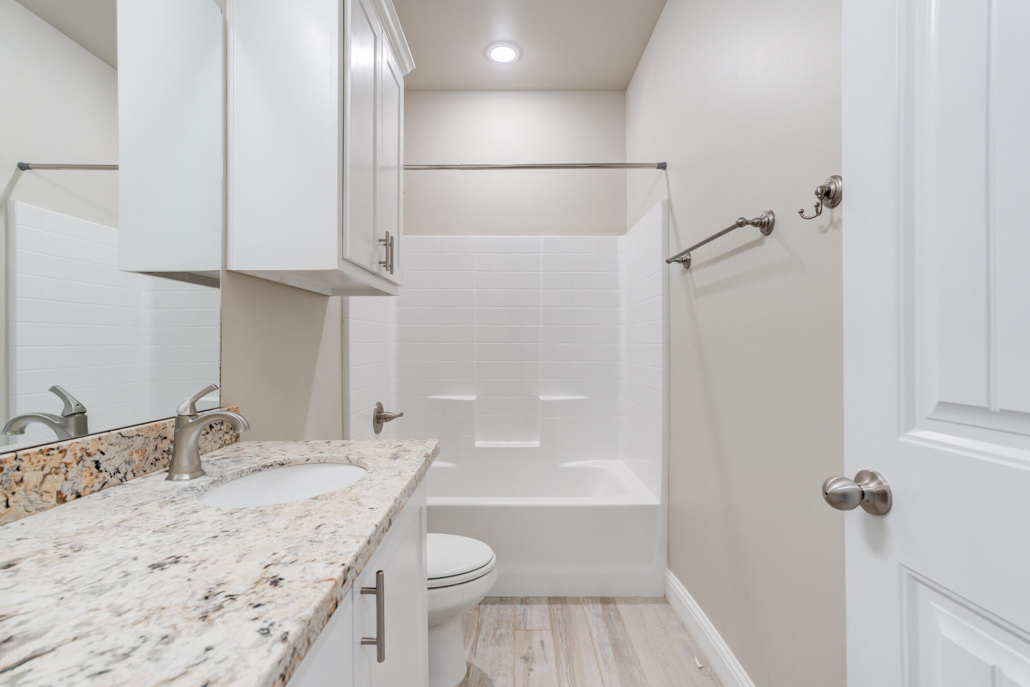 7633 87th Street Lubbock, TX 79424 - Photo 28 of 47 a bathroom with a granite countertop sink toilet and shower