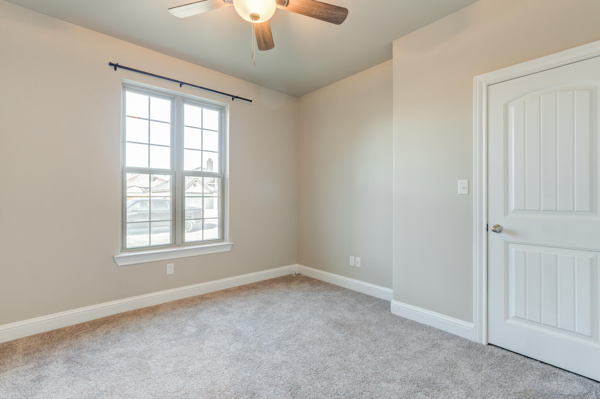 7633 87th Street Lubbock, TX 79424 - Photo 43 of 47 an empty room with a window and a ceiling fan