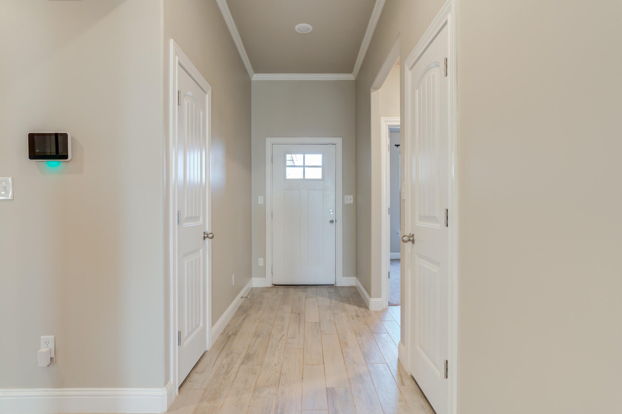 7633 87th Street Lubbock, TX 79424 - Photo 9 of 47 a view of a hallway with wooden floor