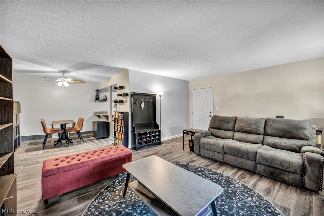 22952 Mastick Road, Unit 203 Cleveland, OH 44126 - Photo 26 of 35 Living room with ceiling fan, a textured ceiling, and dark hardwood / wood-style floors