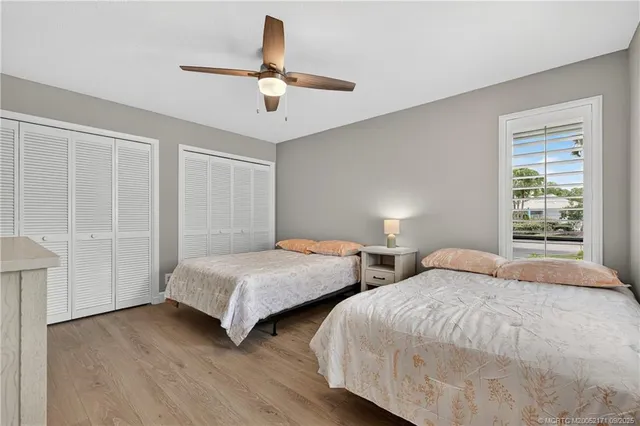 a bedroom with two beds and painting on the wall