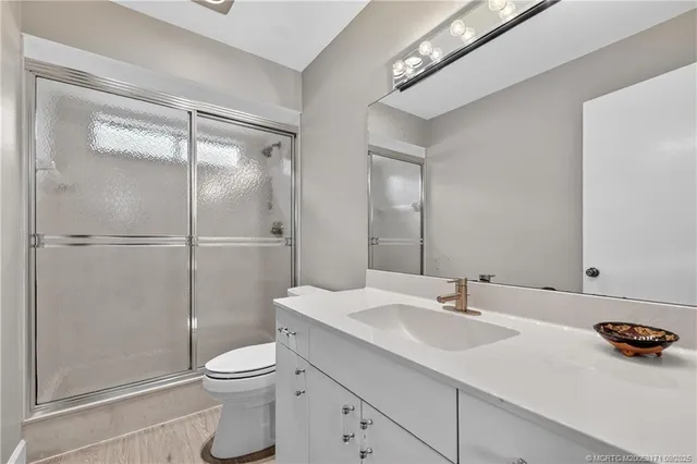 a bathroom with a sink toilet and shower