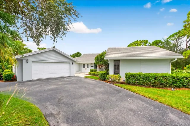 a view of a house with a yard and garage