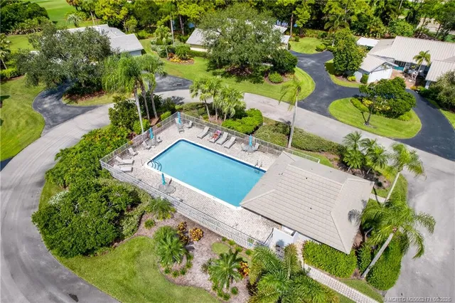 an aerial view of a house with a garden and lots of trees