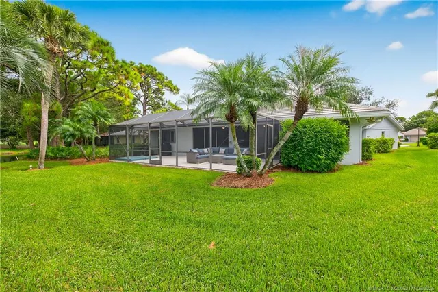 a view of a house with a backyard porch and sitting area