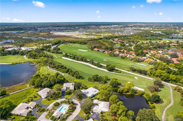 an aerial view of a residential houses with outdoor space