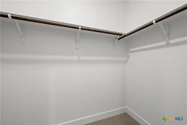 a bathroom with a granite countertop sink a toilet and large mirror