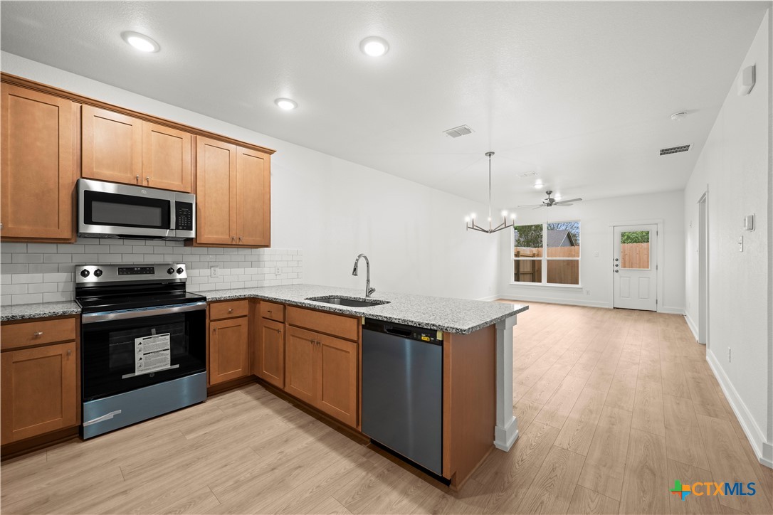 614 Campus Street Troy, TX 76579 - Photo 5 of 18 a kitchen with stainless steel appliances granite countertop a sink stove and microwave