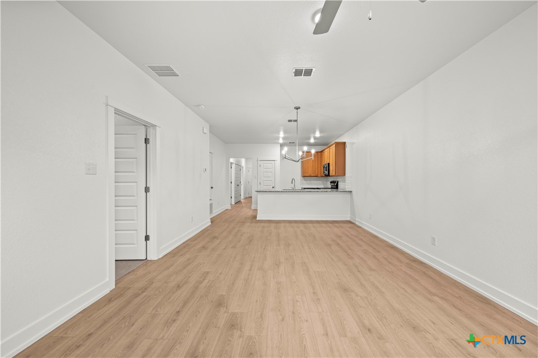 614 Campus Street Troy, TX 76579 - Photo 9 of 18 a view of empty room with wooden floor