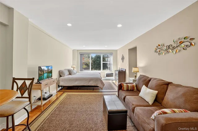 a spacious bedroom with a bed and a couch