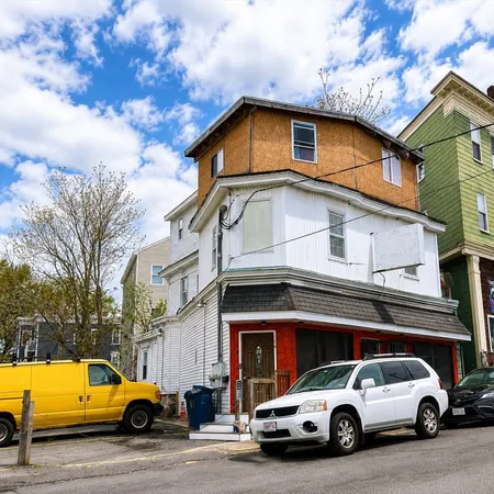 a view of a car parked in front of a house