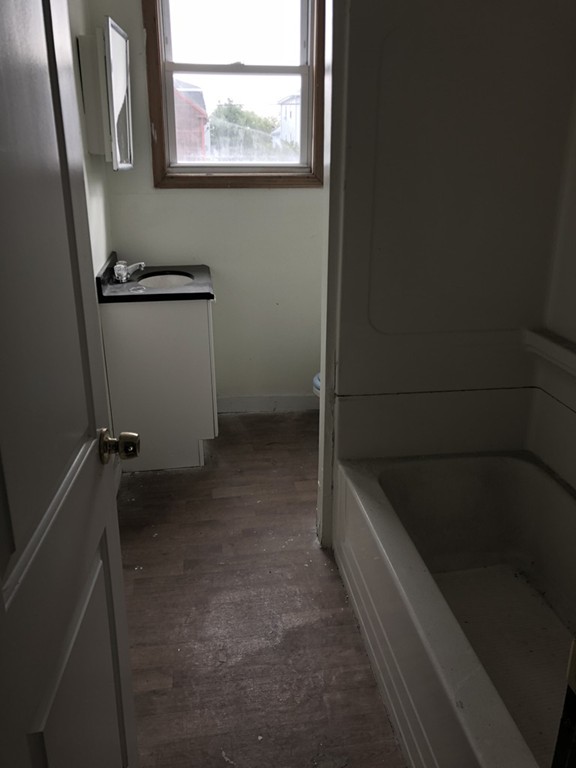 219 Rodman Street Fall River, MA 02721 - Photo 8 of 13 a bathroom with a bathtub