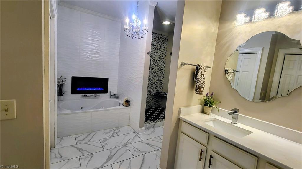 7035 Skylark Road Pfafftown, NC 27040 - Photo 14 of 47 Spa-Inspired Jetted Soaking Tub with Cozy Fireplace Ambiance!