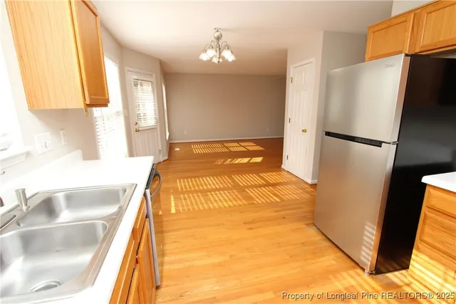 a bedroom with a bed and a refrigerator