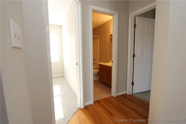 a view of bedroom and bedroom with wooden floor