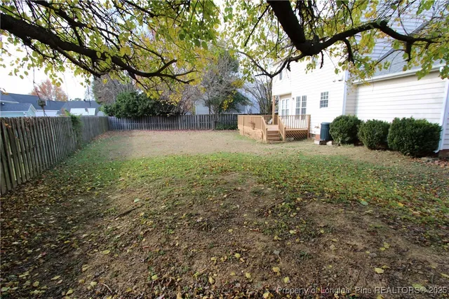 a view of backyard of house with green space