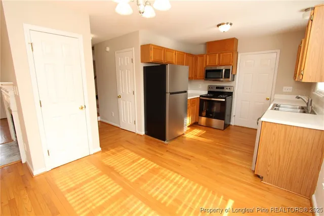 a kitchen with stainless steel appliances a refrigerator and a stove