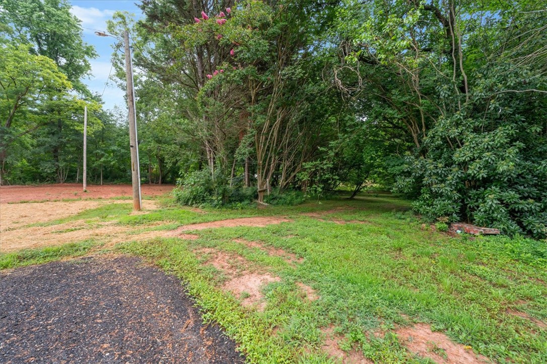 174 Holliday Road Six Mile, SC 29682 - Photo 39 of 49 A spacious 1.3 acre lot with mature trees, offering a tranquil setting for a new workshop or extra large garage