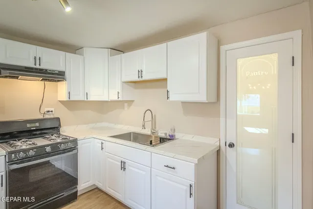 a kitchen with a stove and a sink