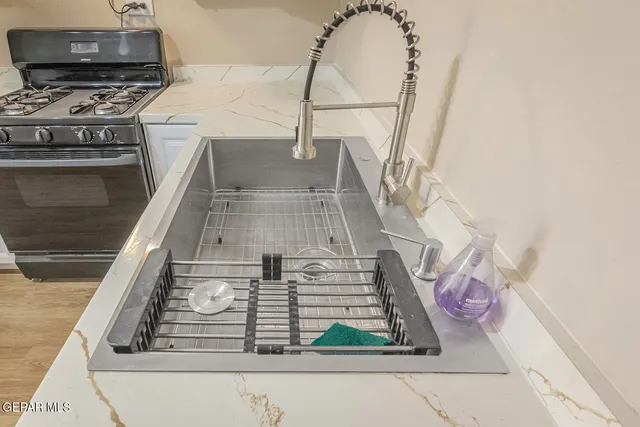 a kitchen with refrigerator a stove a sink and cabinets