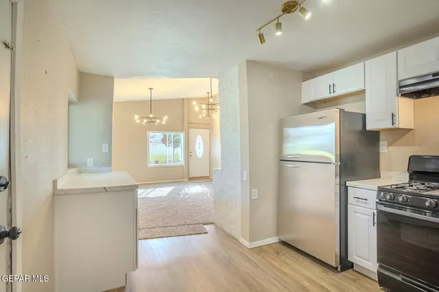 an empty room and chandelier fan