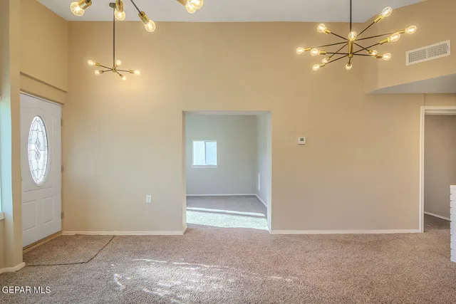 a view of a livingroom with a chandelier fan