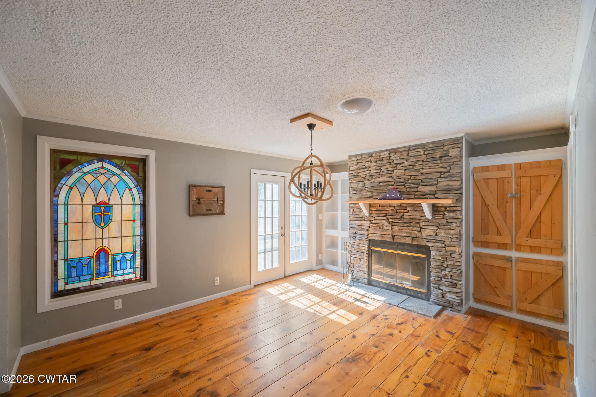 101 Red Ribbon Road Westport, TN 38387 - Photo 14 of 51 wooden floor fireplace and windows in an empty room