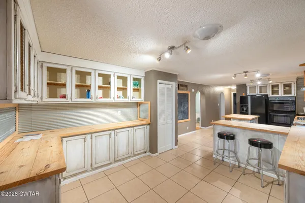a kitchen with a sink a stove a refrigerator and cabinets