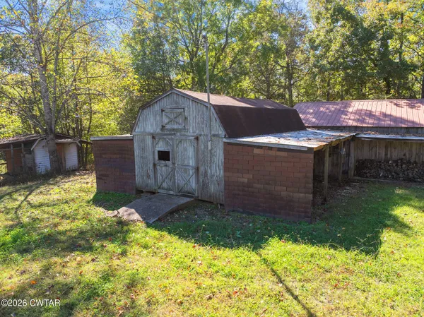 a view of house with backyard and a garden