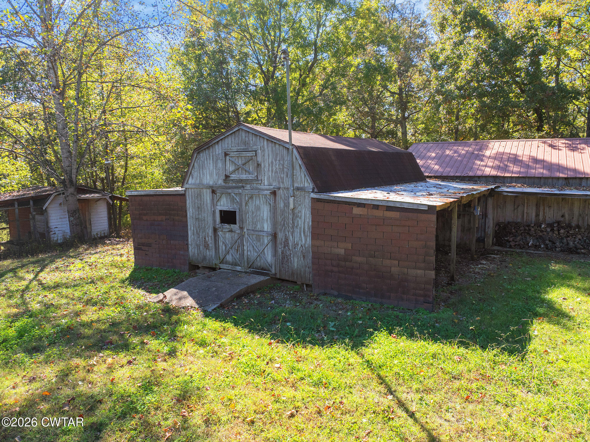 101 Red Ribbon Road Westport, TN 38387 - Photo 7 of 51 a view of house with backyard and a garden