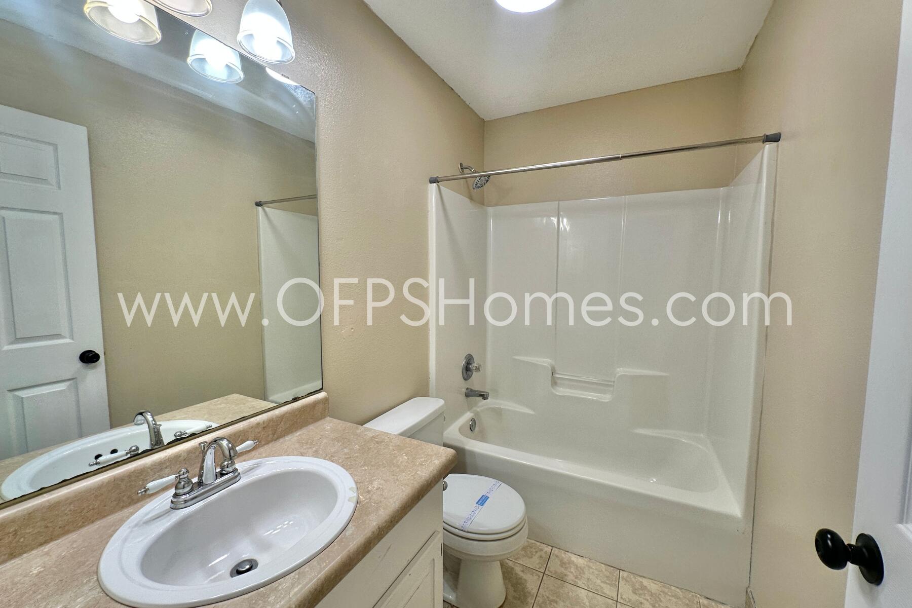 2837 Atoka Trail Crestview, FL 32539 - Photo 12 of 17 a bathroom with a sink a toilet and shower